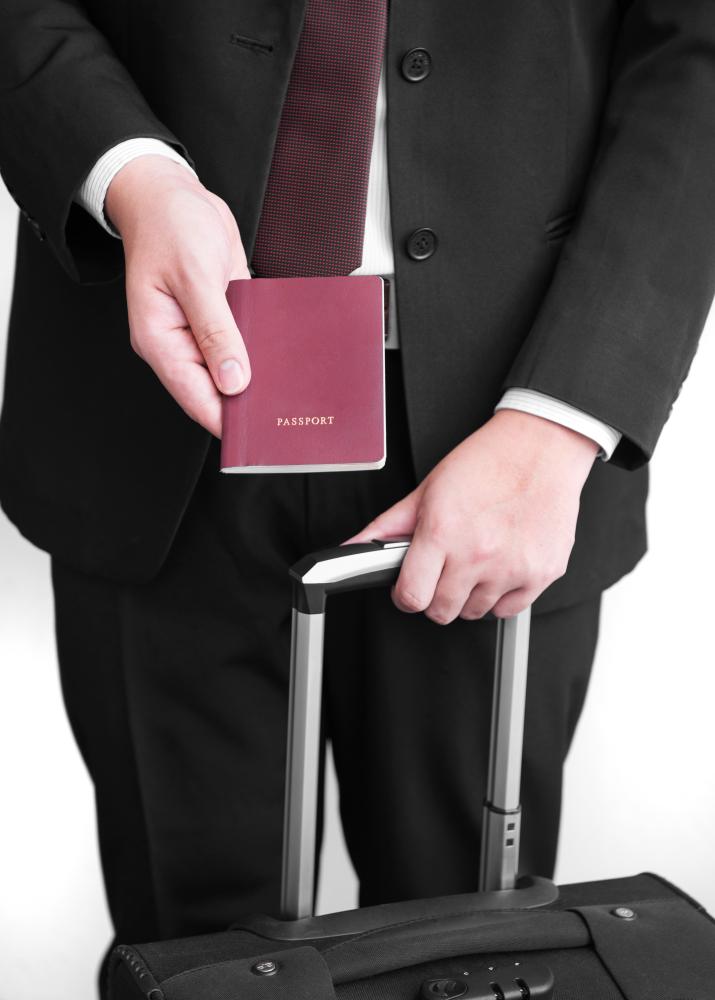 Business professional holding a passport and suitcase, symbolizing urgent travel needs and passport services in Phoenix.